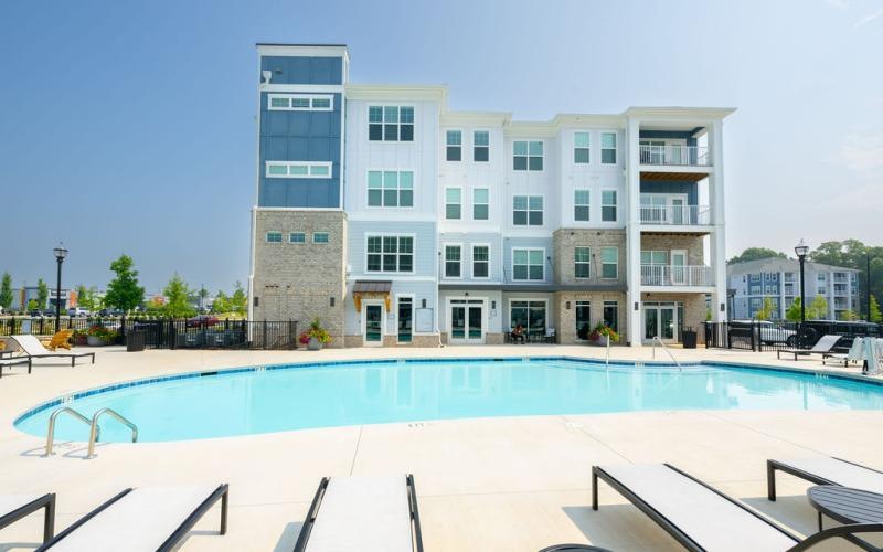 a large white building with a pool