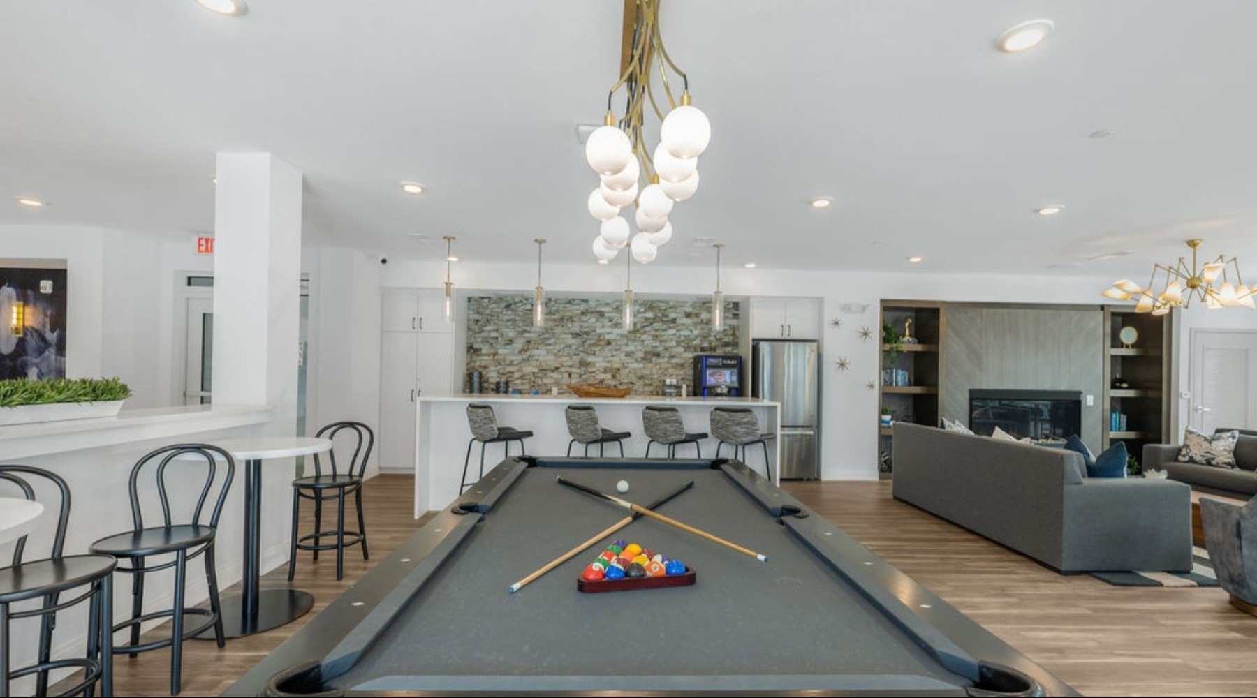 a clubroom with a pool table and chairs