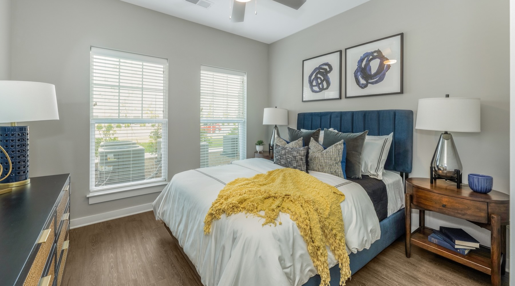 a bedroom with a bed and a fan
