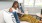a woman sitting on a couch reading a book